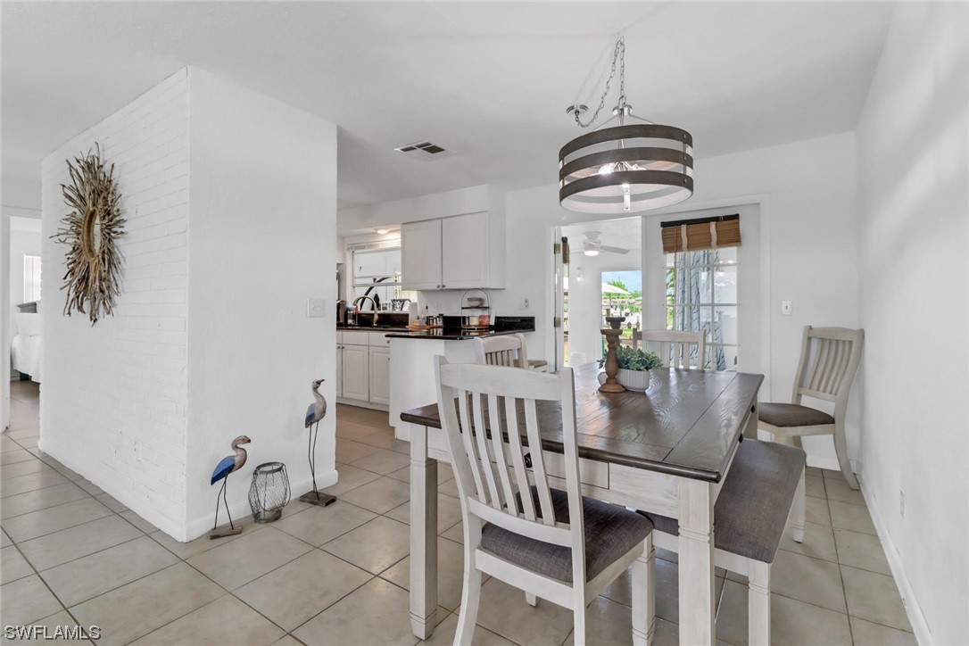 1192 Moody Road North Fort Myers, FL 33903 - Photo 8 of 29 a view of a dining room with furniture and wooden floor