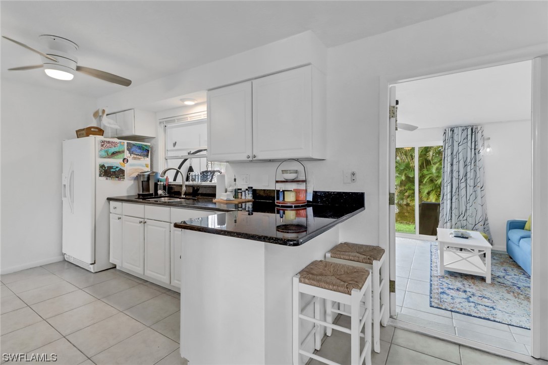 1192 Moody Road North Fort Myers, FL 33903 - Photo 10 of 29 a kitchen with stainless steel appliances granite countertop a stove a sink and a refrigerator
