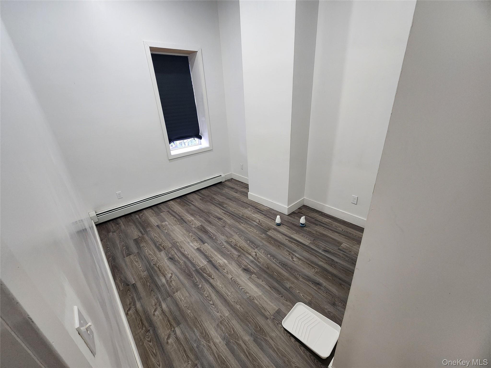 57 Carpenter Avenue Newburgh, NY 12550 - Photo 13 of 16 an empty room with wooden floor