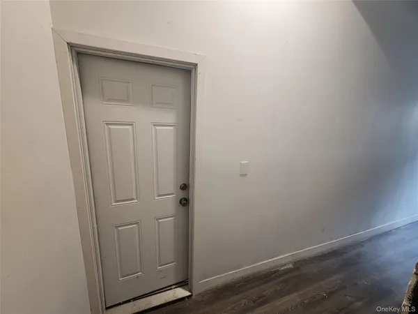 an empty room with wooden floor and closet