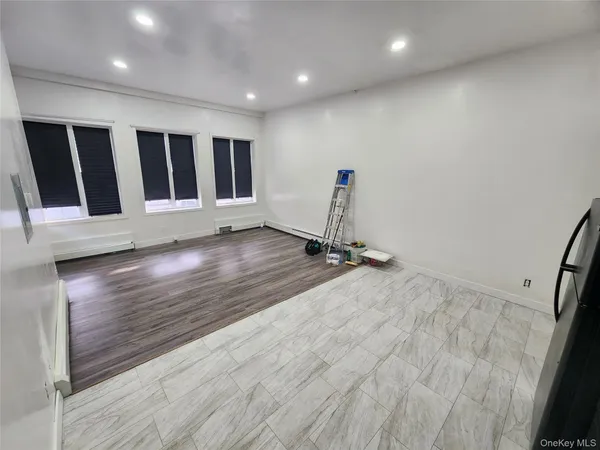 a view of a room with wooden floor and window