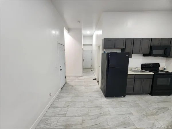 a kitchen with a refrigerator and a stove
