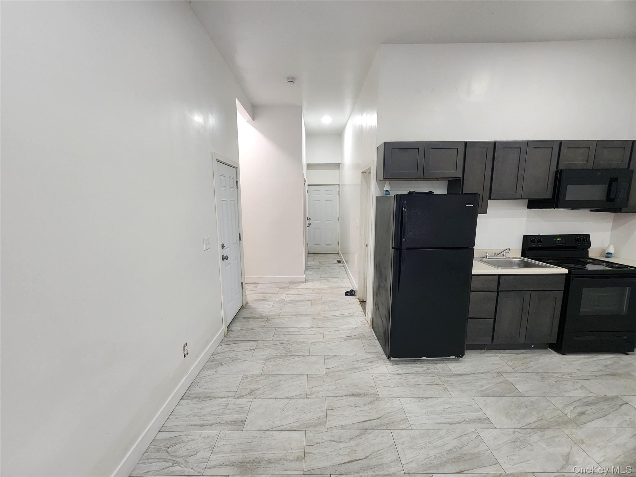 57 Carpenter Avenue Newburgh, NY 12550 - Photo 8 of 16 a kitchen with a refrigerator and a stove