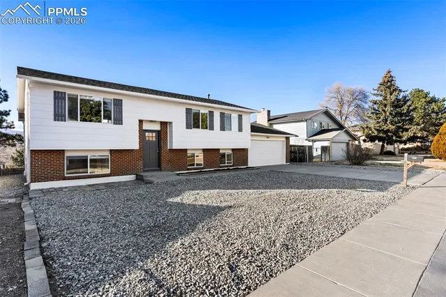 a house that has a tree in front of it