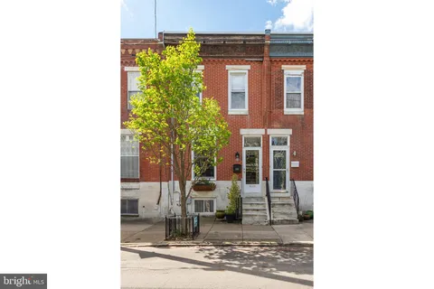 a view of a brick house with a large windows