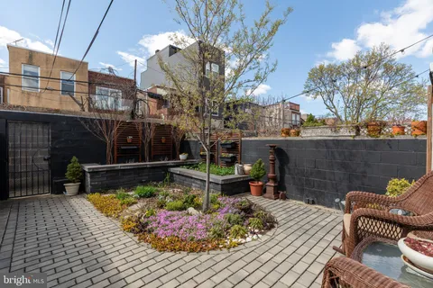 a view of a chairs and tables in the back yard of the house