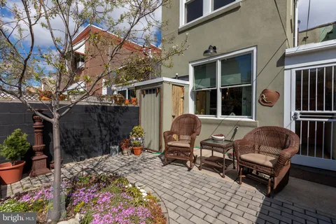 a backyard of a house with yard fire pit and outdoor seating
