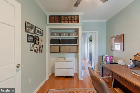 a room with a table and a book shelf