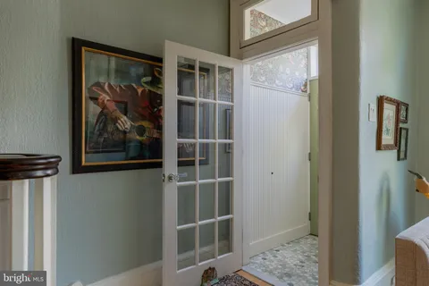 a view of a hallway with wooden floor and closet