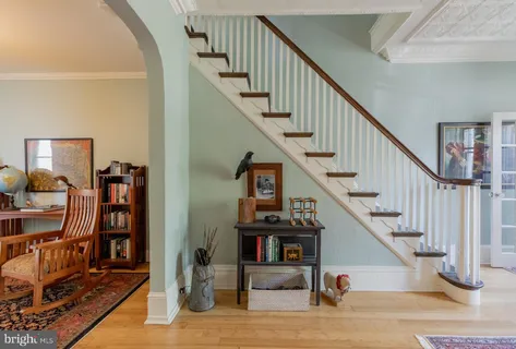 a view of entryway livingroom and hall with wooden floor