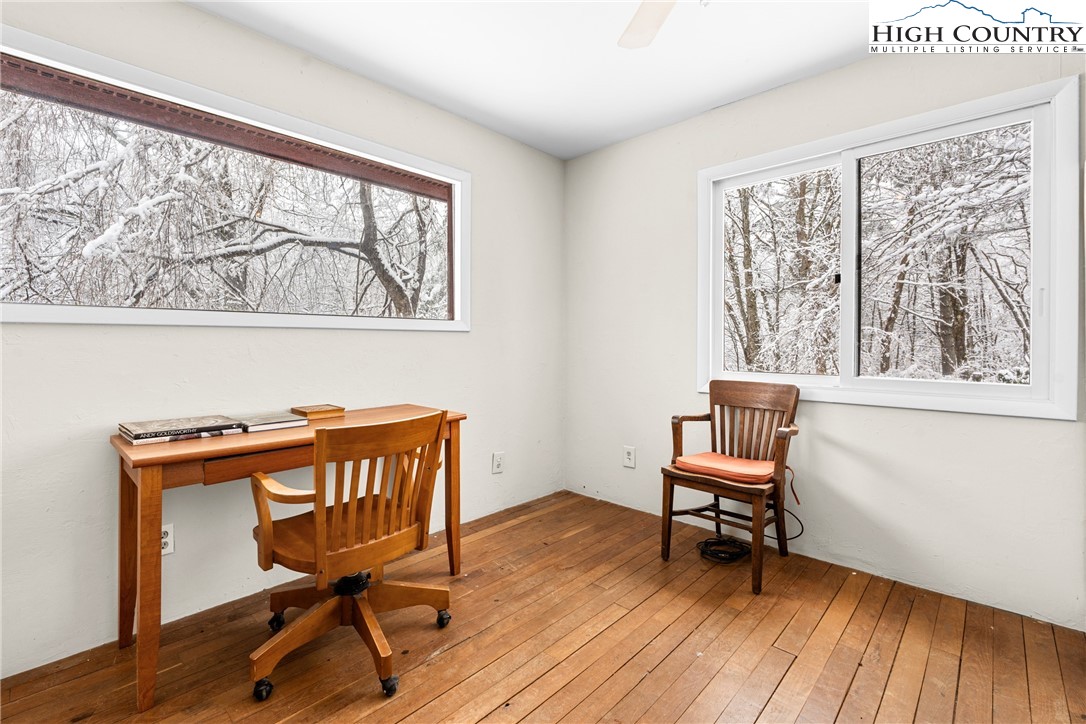 1355 Pine Run Road Boone, NC 28607 - Photo 15 of 37 a view of a workspace with wooden floor and a window