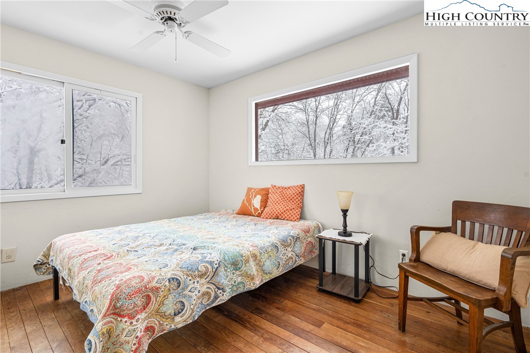 1355 Pine Run Road Boone, NC 28607 - Photo 17 of 37 a bedroom with a bed and wooden floor