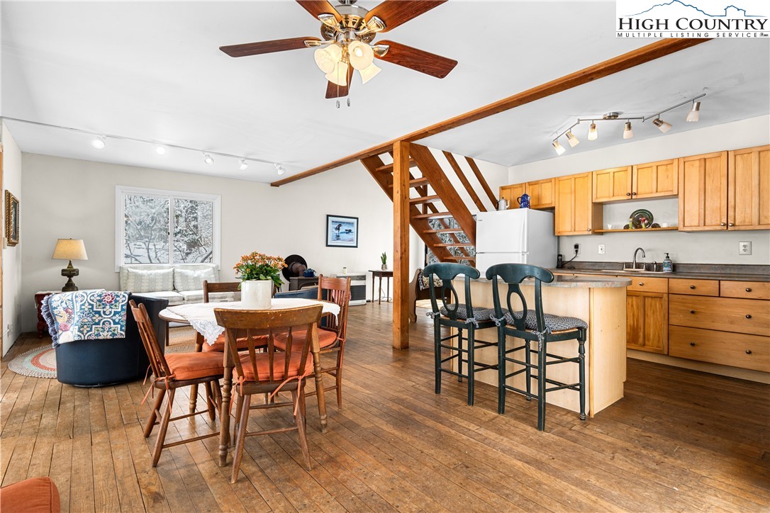 1355 Pine Run Road Boone, NC 28607 - Photo 2 of 37 a open kitchen with stainless steel appliances kitchen island granite countertop a table and chairs in it