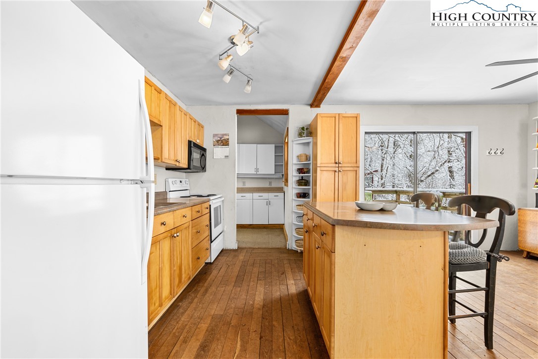1355 Pine Run Road Boone, NC 28607 - Photo 10 of 37 a view of a kitchen with kitchen island a large counter top space a sink stainless steel appliances and cabinets