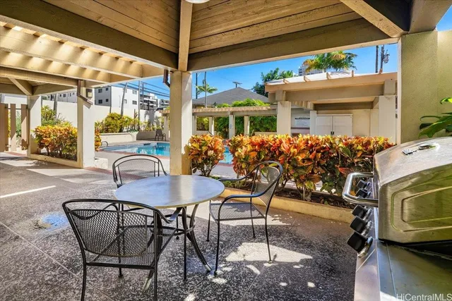 a view of a patio with table and chairs potted plants