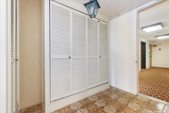 a view of hallway with a balcony and bathroom