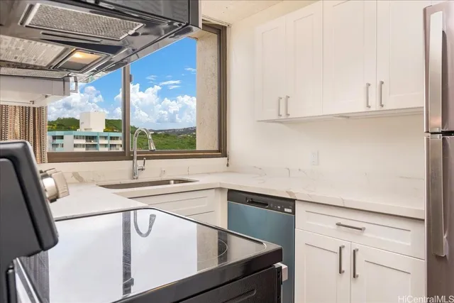 a kitchen with a sink window and cabinets