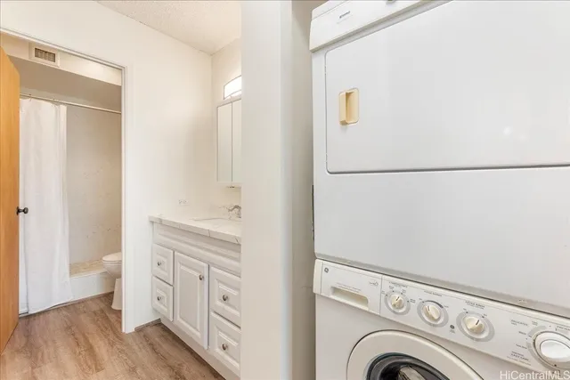 a view of washer and dryer with wooden floor