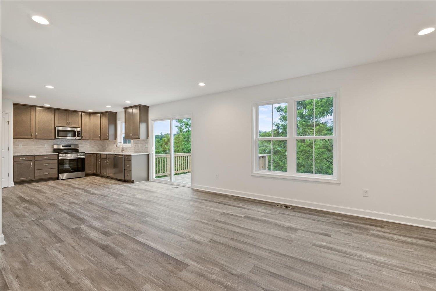 a view of a kitchen with a sink and a large window
