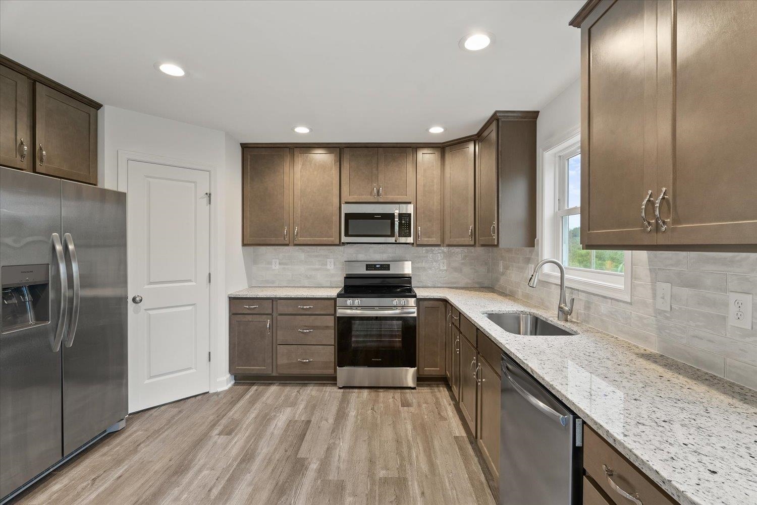 Lot 8 Middlebrook Avenue Staunton, VA 24401 - Photo 11 of 39 a kitchen with granite countertop stainless steel appliances and wooden cabinets