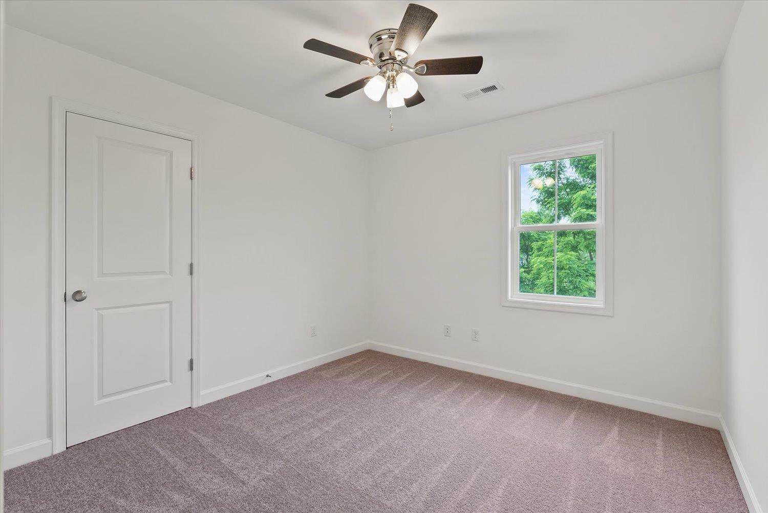 Lot 8 Middlebrook Avenue Staunton, VA 24401 - Photo 19 of 39 an empty room with a window and a fan