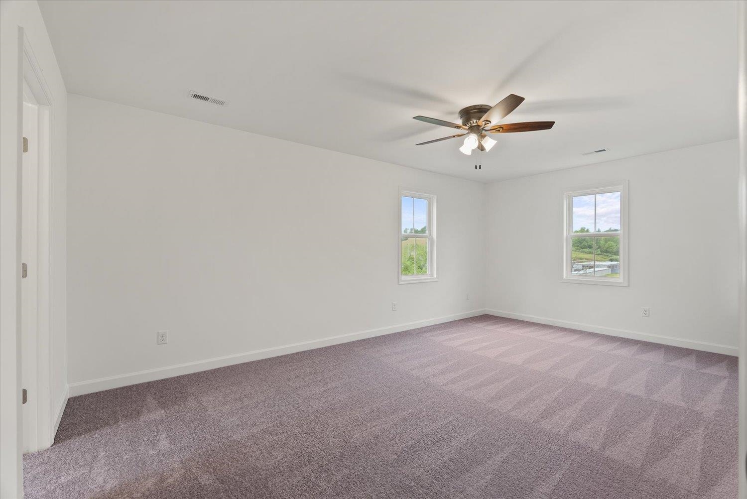 Lot 8 Middlebrook Avenue Staunton, VA 24401 - Photo 24 of 39 an empty room with windows and a ceiling fan