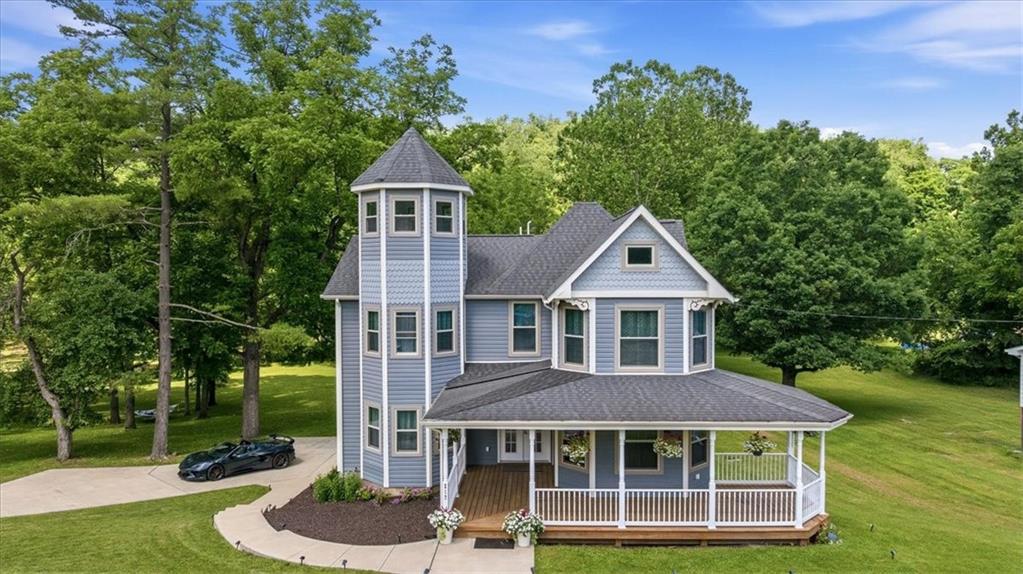 217 Country Club Road Washington, PA 15301 - Photo 1 of 50 Restored 1880s Victorian estate on 27.2 acres in Washington County, PA — blue siding, third-story octagon tower, and a 32-foot covered front porch