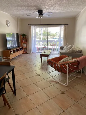 a bedroom with furniture and large windows