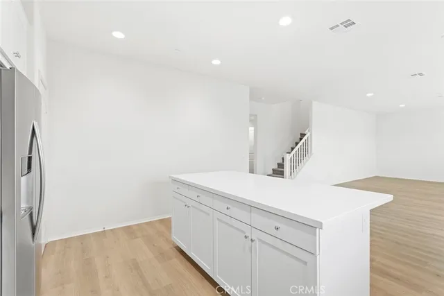 a kitchen with a sink dishwasher and a refrigerator