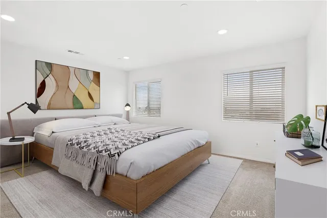 a bedroom with a bed and a couch