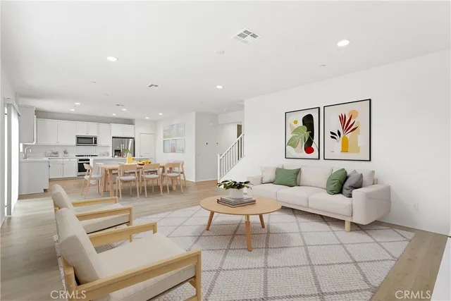 a living room with furniture and kitchen view