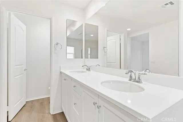 a bathroom with 2 sink and a mirror
