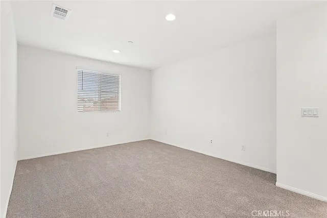 an empty room with a empty space and window