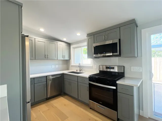 a kitchen with a sink stove and microwave