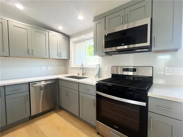 a kitchen with stainless steel appliances a stove a microwave and cabinets
