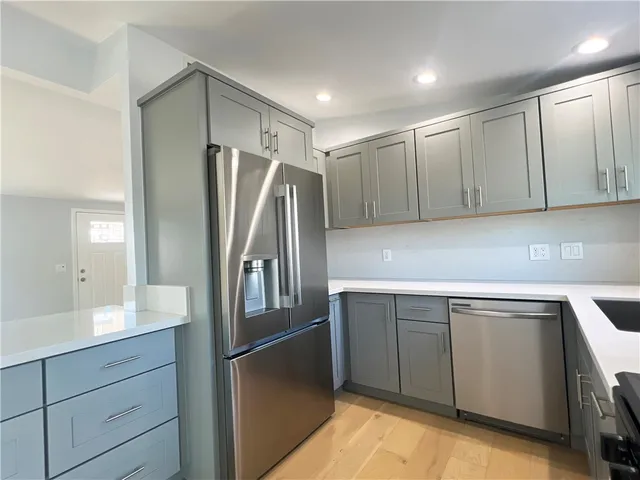 a kitchen with appliances and cabinets
