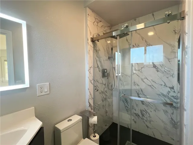 a bathroom with a shower and a toilet