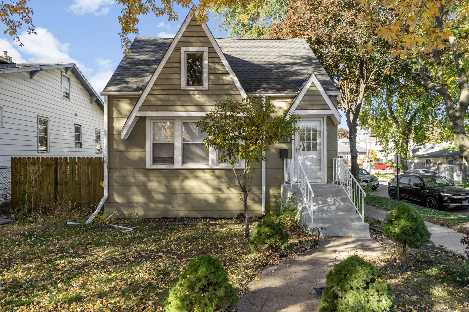 a view of a brick house with many windows next to a yard