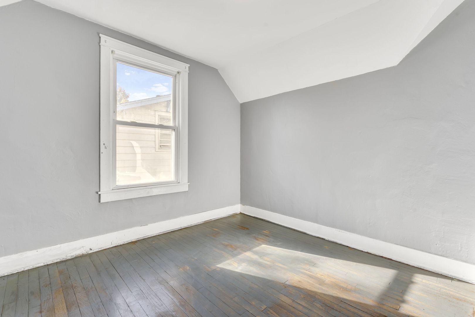 5402 South 73rd Avenue Summit, IL 60501 - Photo 14 of 17 an empty room with wooden floor and windows