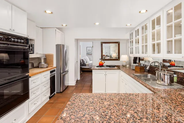 a kitchen with stainless steel appliances granite countertop a refrigerator stove microwave and sink