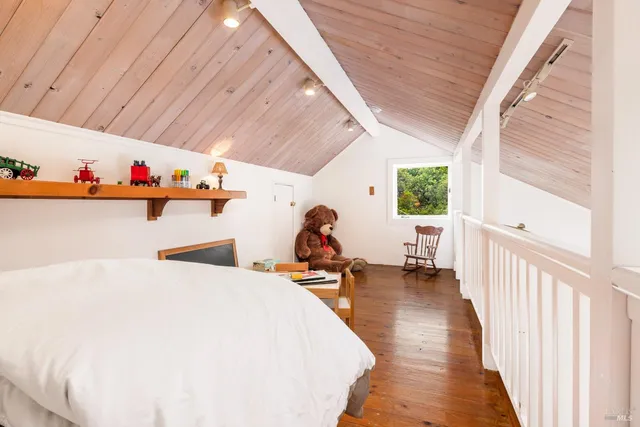 a bed room with a bed and a large window with wooden floor