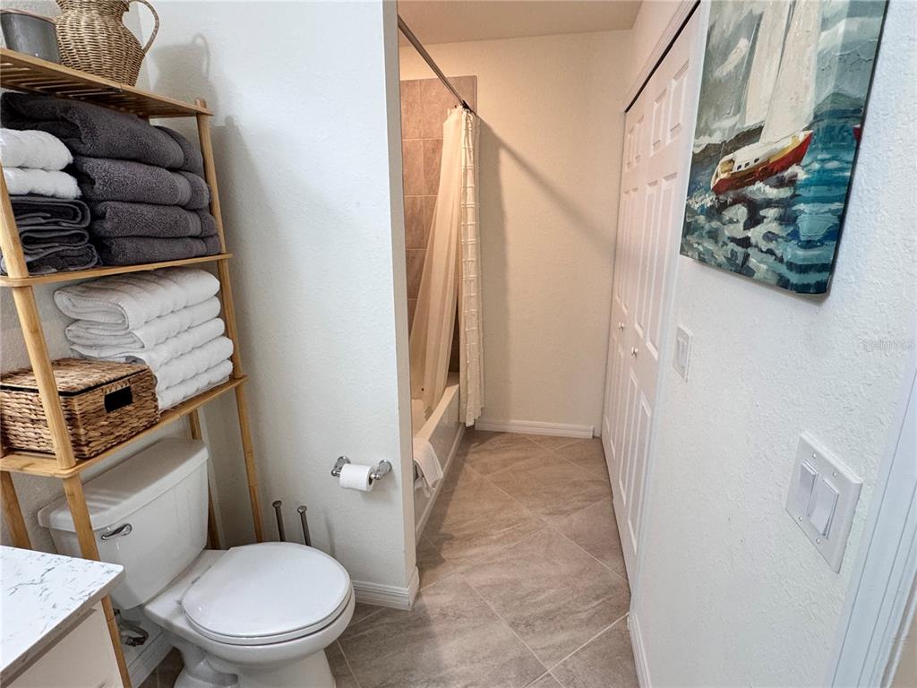 17724 Gawthrop Drive, Unit 304 Bradenton, FL 34211 - Photo 11 of 38 a white toilet sitting next to a shower curtain