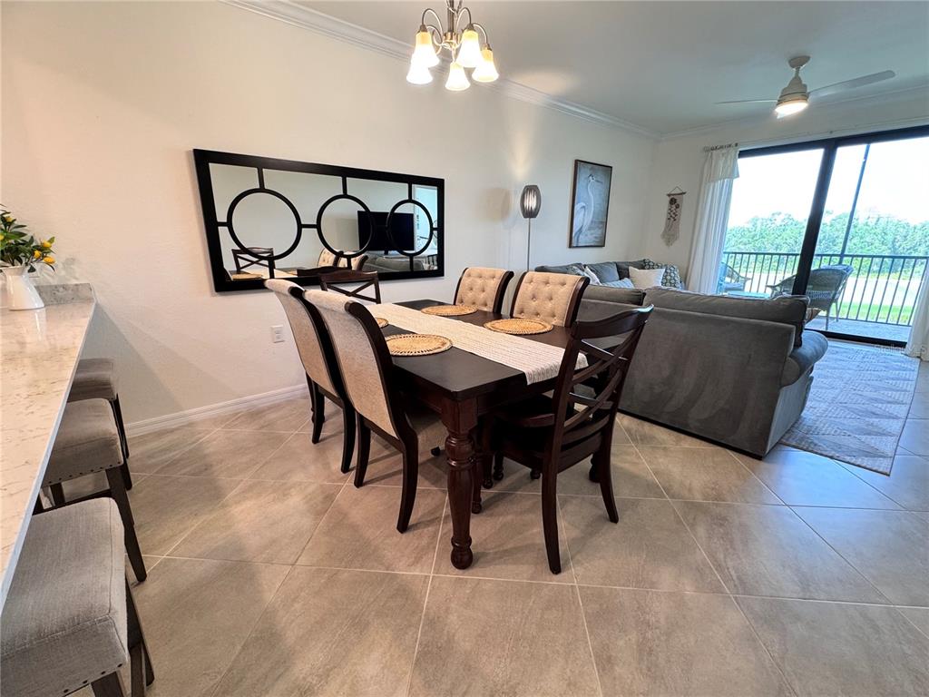 17724 Gawthrop Drive, Unit 304 Bradenton, FL 34211 - Photo 18 of 38 a living room with furniture a window and a chandelier