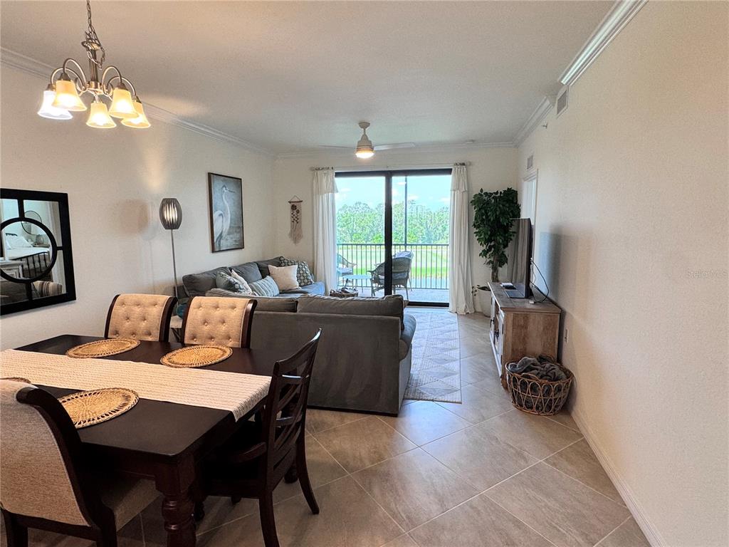 17724 Gawthrop Drive, Unit 304 Bradenton, FL 34211 - Photo 20 of 38 a living room with furniture and a chandelier