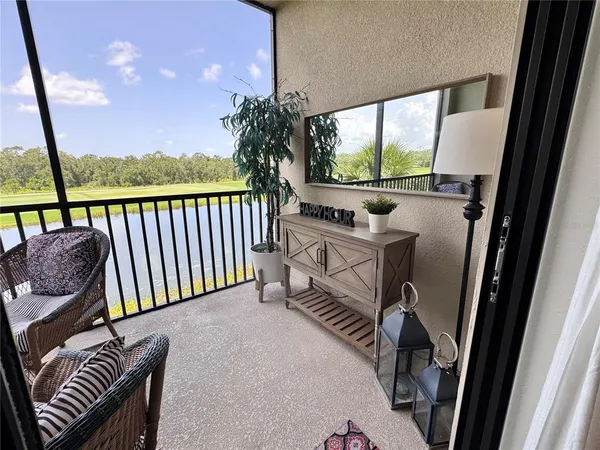 a view of a balcony with furniture and front door