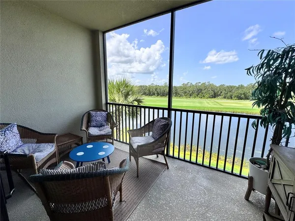 a view of a patio with a table & chairs