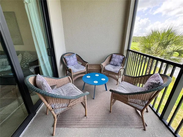 a view of a porch with furniture and a yard