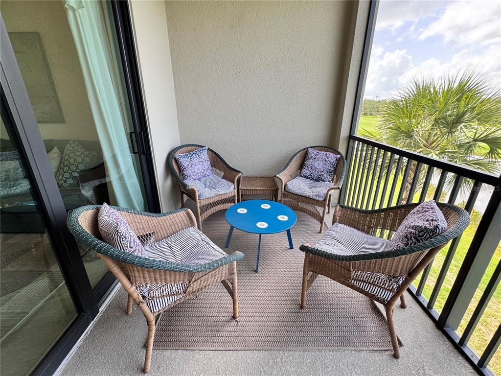 17724 Gawthrop Drive, Unit 304 Bradenton, FL 34211 - Photo 27 of 38 a view of a porch with furniture and a yard