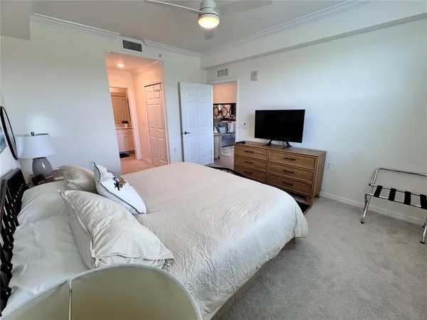 a bedroom with a bed and a television