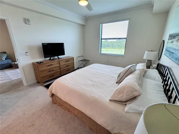a bedroom with bed and a flat screen tv